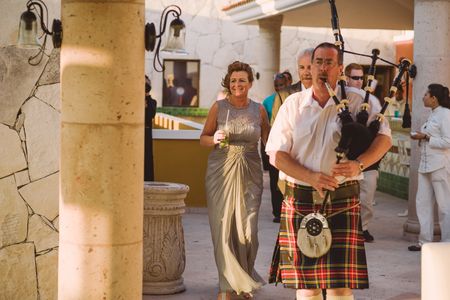 Bagpiper Gordon MacDonald plays the bride and groom down the aisle.