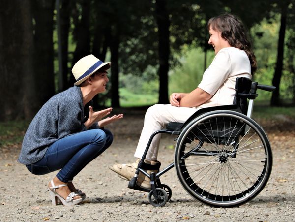 Woman cheering up a disabled person