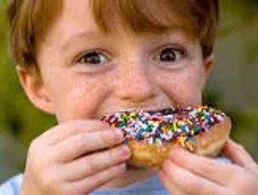 Enjoying a sprinkled donut.