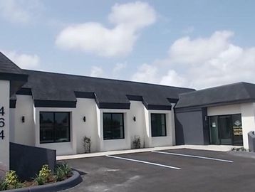 Modern commercial building with parking spaces.