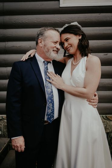 Bride and older man sharing a warm, joyful moment together.