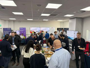 People mingling and enjoying food at a professional networking event.