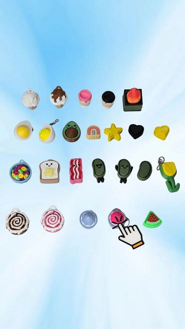 Colorful food and object keychain charms arranged in rows on a blue background.