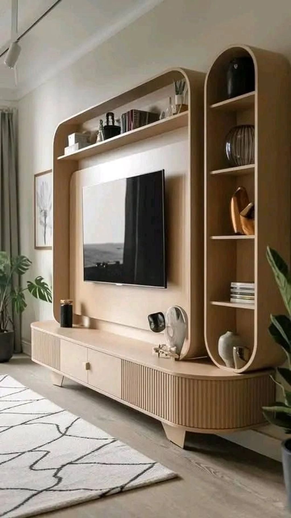 Modern wooden TV unit with rounded edges and decorative shelves in a cozy living room.