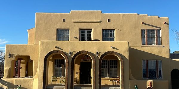 Adobe-style southwestern building with arched entryways.