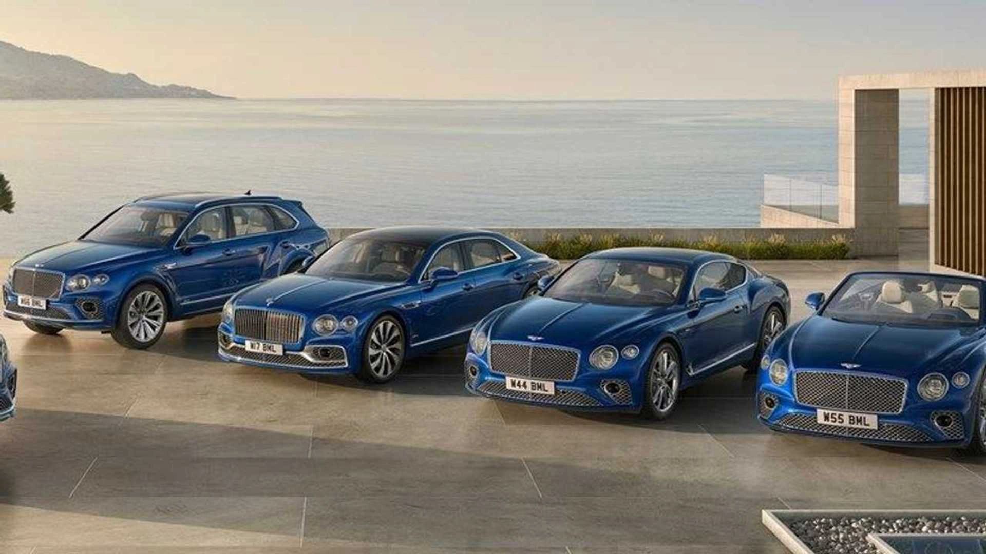 A lineup of luxury blue Bentley cars parked near a modern house by the sea.