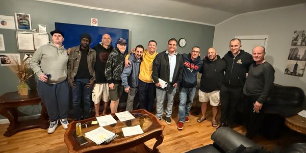 A group of men posing together in a cozy living room.