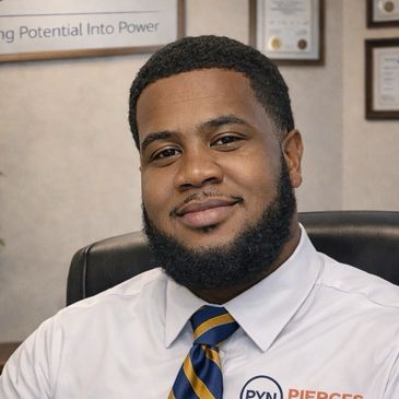 Professional man smiling in office setting with tie and branded shirt.
