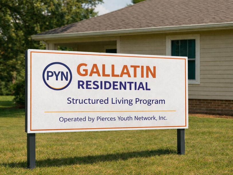 A sign for PYN Gallatin Residential Structured Living Program outside a house.