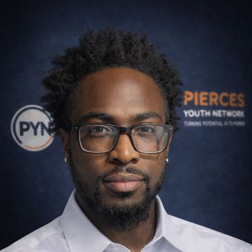 Man with glasses and beard posing in front of a branded backdrop.