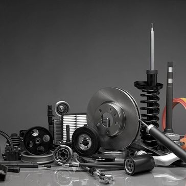 A collection of various automotive spare parts arranged together.