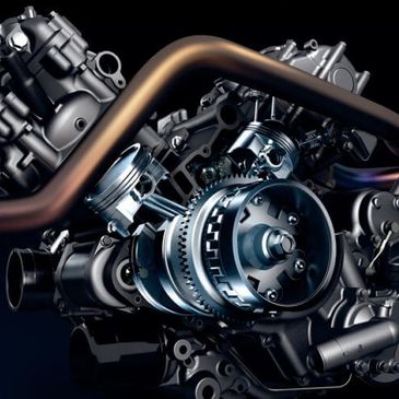 Close-up of a mechanical engine with pistons and exhaust pipes.