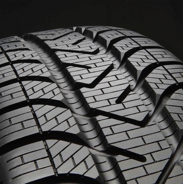 Close-up of a car tire tread showing detailed patterns.