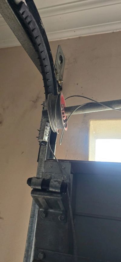a picture of a Brocken garage door the balancing bar came off the cable was snapped and the garage d