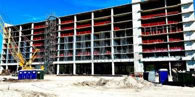A building under construction with a crane and scaffolding.