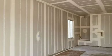Interior of a room under construction with drywall installed.