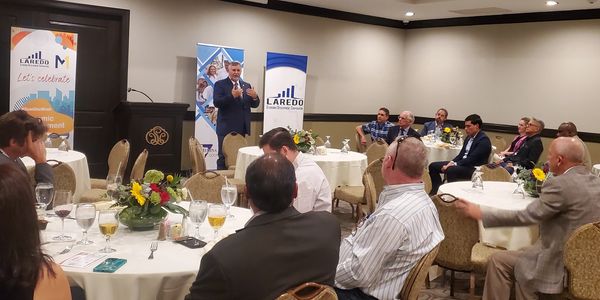 A speaker addressing an audience at a Laredo Economic Development event.