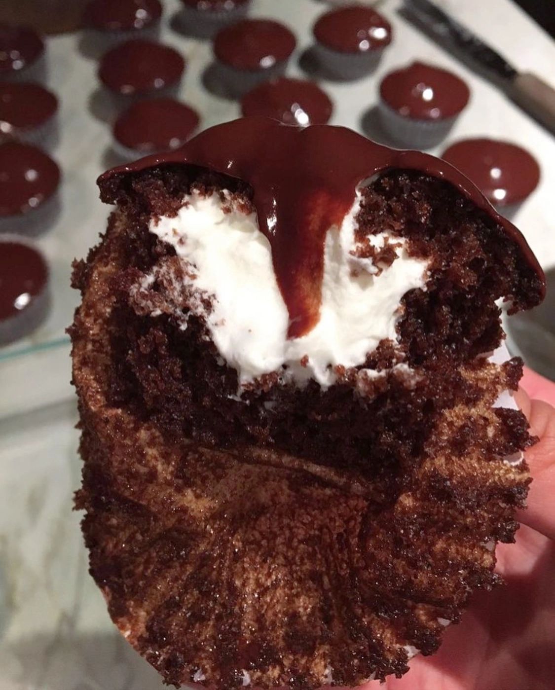 Chocolate ganache cupcake filled with whipped cream
