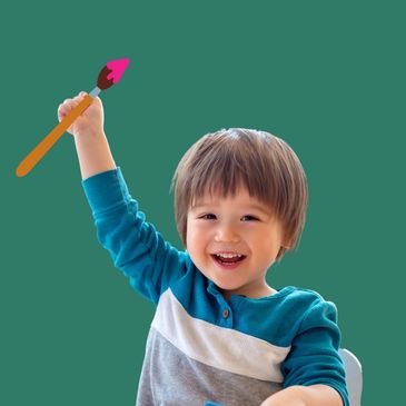 Boy with paintbrush for Paint and Play class at Wondergarden