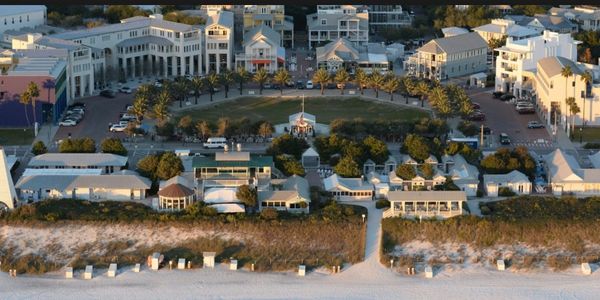 Aerial view of a beachside resort with buildings and greenery.