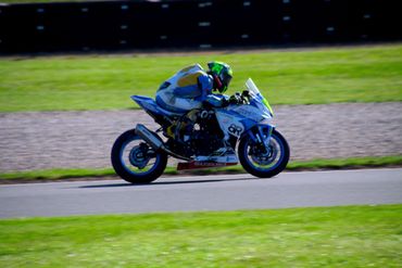 Motorcyclist racing on a track.