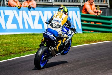 Motorcycle racer speeding on track.