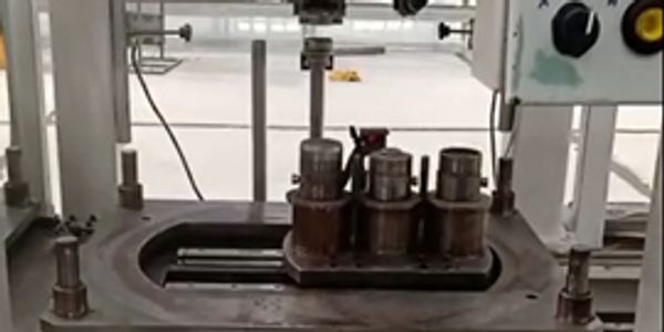 Industrial filling machine with metal containers.