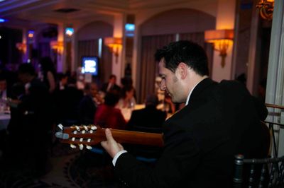 tom butterworth plays guitar at a corporate event