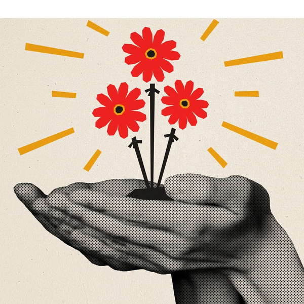A hand holding three red flowers with yellow rays shining around.
