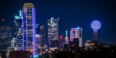 City skyline illuminated with vibrant neon lights at night.