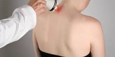 woman being treated for a neck injury with a laser