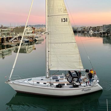 sailboat on calm water at sunset