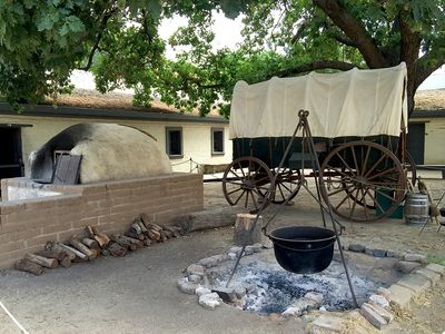 East Sacramento- Conestoga wagon near fire pit at Sutter's Fort. welcome-waggin.com