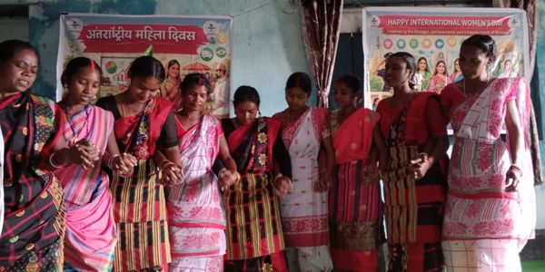 A group of women in traditional attire celebrating International Women's Day.