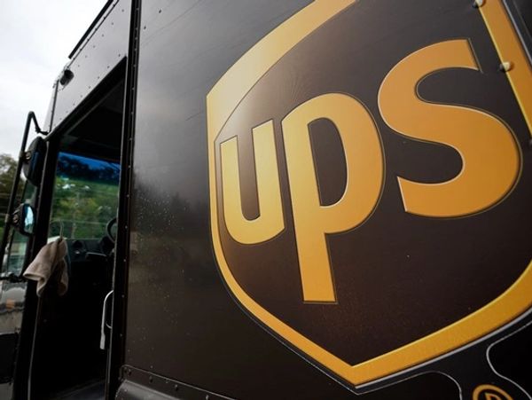 Close-up of a UPS delivery truck with the logo prominently displayed.