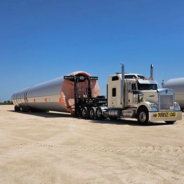 Truck loaded with wind energy component.