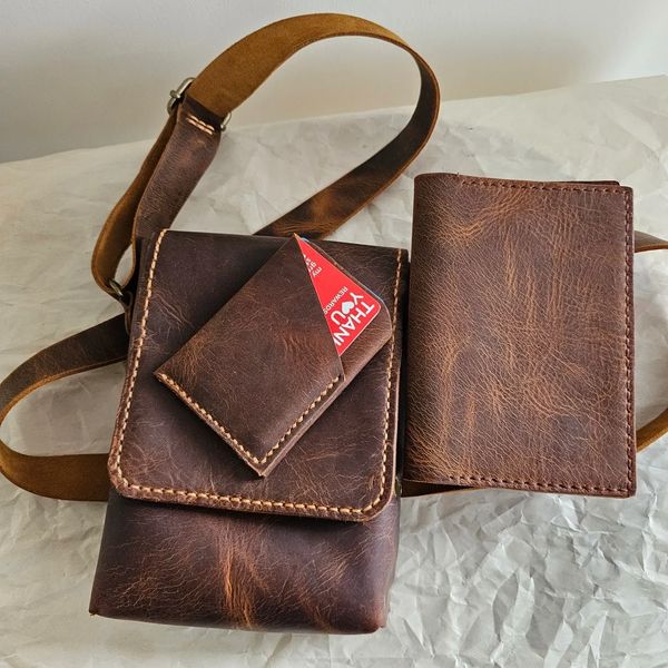 A handcrafted leather set featuring a crossbody bag, a card holder, and a passport holder .