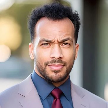 Confident man in a suit with a focused expression.