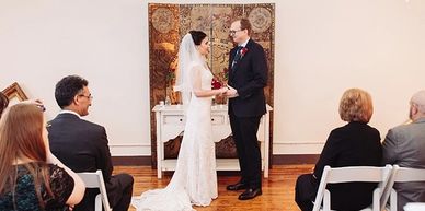 Couple exchanging vows at a small wedding ceremony.