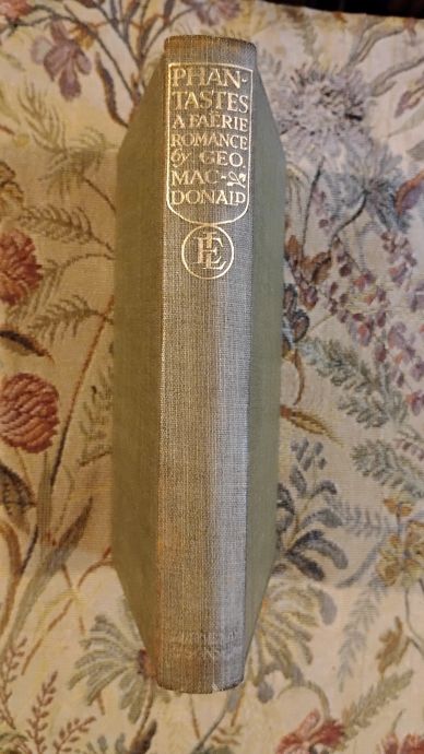 Spine of an old book titled "Phantastes" by Geo. MacDonald.