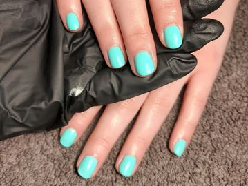 Freshly painted turquoise nails.