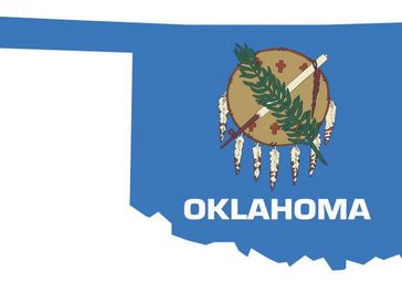State flag of Oklahoma presented over the state of Oklahoma.