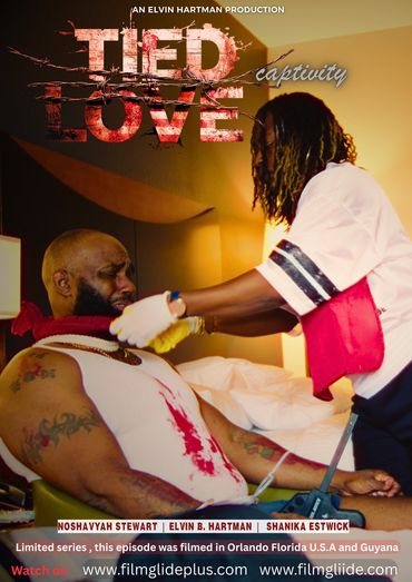 A man with bloodstains is tied up while a woman tends to him in a dramatic scene.