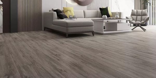 Modern living room with gray sectional sofa and wood-textured flooring.