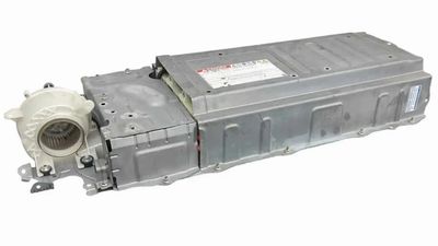 A rectangular metallic electronic component with connectors and a white plastic part.