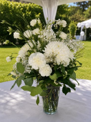 Elegant white floral arrangement in glass vase.