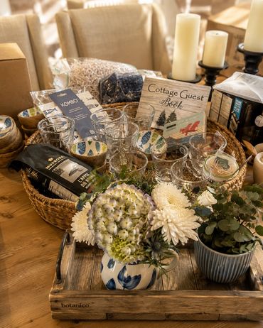 Cozy cottage guest setup with flowers and candles.
