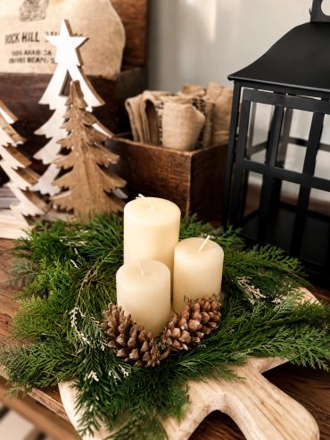 Christmas candles and pinecones centerpiece.