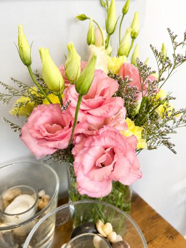 Pink and yellow flower bouquet in a vase.
