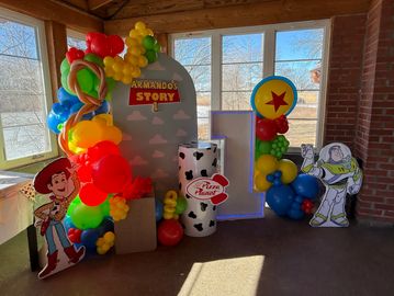 Toy Story-themed birthday party decorations with colorful balloons.